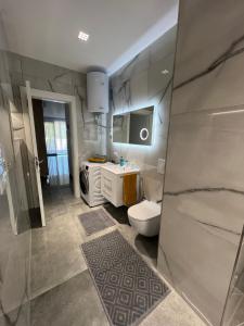 a bathroom with a toilet and a sink at Rent Apartament Lalzy Bay in Durrës +24 photos