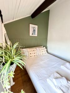 a bed in a room with a plant at Ropewalks City Centre Apartment with Roof Terrace in Liverpool