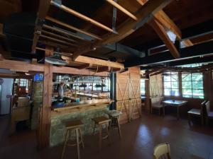 a bar in a restaurant with wooden walls at Areál Kamínka - POKOJE A APARTMÁNY in Roštín +22 photos
