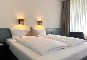 Postel nebo postele na pokoji v ubytování Auszeit Hotel Hamburg
