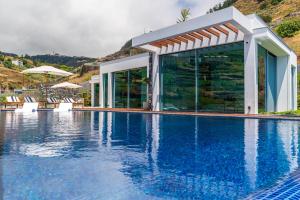 a villa with a swimming pool in a mountain at Refúgio na Escarpa Luxury Villa in Quinta Grande