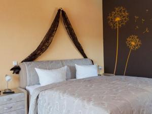 a bedroom with a white bed with a large headboard at Pension am Hasenberg in Markische Heide +13 photos