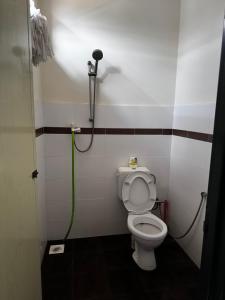 a bathroom with a toilet and a shower at Jagapuri Homestay Jasin Melaka in Jasin +13 photos