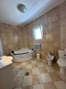 a bathroom with a tub and a toilet and a sink at Villa Noble in Dobra Voda +10 photos