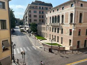 an empty street in a city with buildings at Da Lydia in Treviso