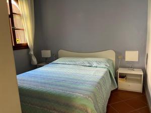 A bed or beds in a room at Porto Coda Cavallo Salina Bamba