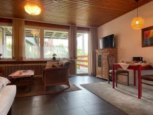 a living room with a table and a dining room at Berghof Arnika in Sankt Andreasberg