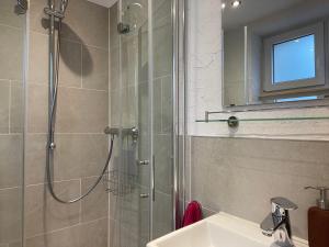a bathroom with a shower and a sink at Berghof Arnika in Sankt Andreasberg +31 photos