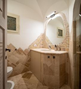 een badkamer met een wastafel en een spiegel bij Sherden suites - Your House in Sardinia in Golfo Aranci
