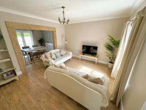 a living room with two couches and a table at Kionslieu Farm Cottages in Foxdale