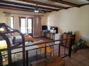 a living room with a bunk bed and a kitchen at Langberg Guest Farm in Kimberley