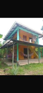 a building with a porch with a bench in front of it at The Orange House in Big Corn Island