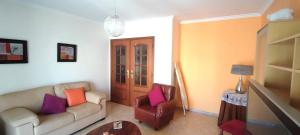 a living room with a couch and a chair at Apt 3 Quartos, Terraço, Centro, Prestige For Home in Loulé +30 photos