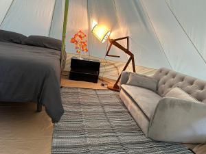 a living room with a bed and a couch at Tiendas Safaris in Ripoll