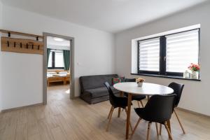 a living room with a table and chairs and a couch at Apartments Žiar 114 in Žiar