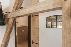 a room with wooden beams and a tv on a wall at Reethus 22 Loft 6 in Timmendorfer Strand
