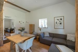a living room with a couch and a table at Reethus 22 Loft 2 in Timmendorfer Strand +26 photos