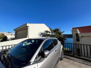 a silver car parked in front of a house at Seacoast apartments MELIHA in Neum +3 photos