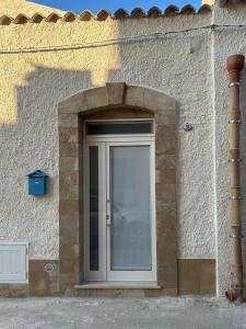 una puerta en un edificio de piedra con un arco en Dimora Claramare, en Marzamemi
