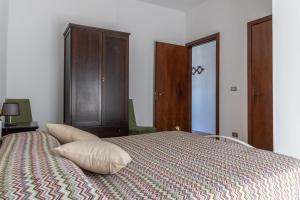 a bedroom with a bed with a wooden cabinet at La casa dei Nonni in San Giorgio Lucano