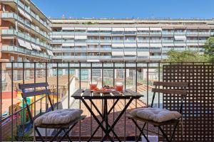 a table and chairs on a balcony with a building at BBarcelona Sagrada Familia Flats in Barcelona
