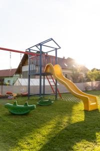 a playground with a slide in the grass at Apartments Žiar 114 in Žiar