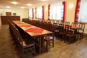 a dining room with wooden tables and chairs at Penzion Taurus in Litomyšl