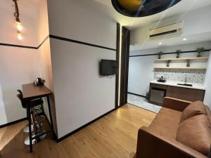 a living room with a couch and a table at Seeds Hotel Puchong Koi in Puchong