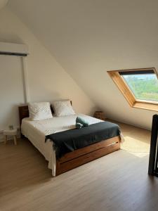 a bedroom with a bed and a large window at Duplex vue mer - piscine - 5 min des plages in Le Gosier +25 photos