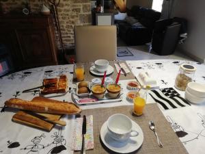 a table with breakfast foods and drinks on it at Kerlan 5 in Béganne +30 photos