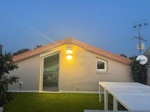 a house with a table in front of it at Quercus Hom&xperiences in Villa Gorizia
