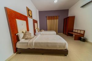 Postel nebo postele na pokoji v ubytování Zaki Hotel Apartment