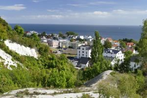 a town on a hill with the ocean in the background at Ferienwohnung Lorenz in Sassnitz