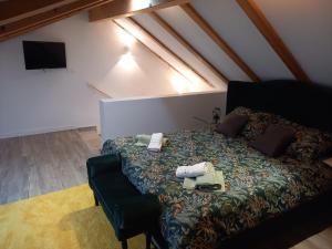 a bedroom with a bed and a chair in a attic at Casa Benessere Istria in Vodnjan