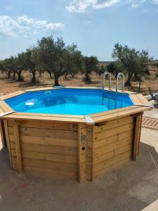 a hot tub in a wooden deck with a pool at Quinta Monte da Azinheira in Amareleja