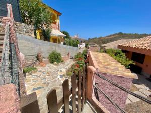 a set of stairs leading up to a house at Casa con giardino con climatizzatore!!! in Costa Rei