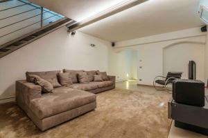 a living room with a couch and a tv at LUVI - Pietro Custodi in Milan