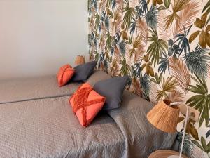 a bed with four pillows on it with a wall at Apartamento Olimpic Beach in Roquetas de Mar +39 photos