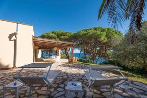 a patio with two chairs and a table at Capo d'Arco Apartments in Capo D'Arco
