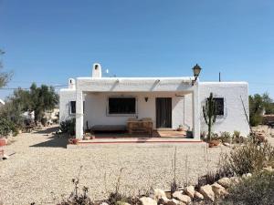 a white house with a patio in front of it at Cortijo El Ventorrillo de Agua Amarga in Almería