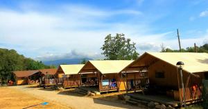 a row of small buildings with roofs on them at Càmping Parc Gualba in gualba de Dalt