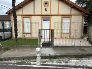 a house with a gate in front of it at Maison EZA in Saint-Yrieix-sur-Charente