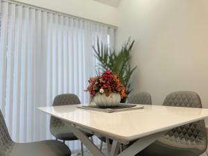 a white table with a vase with flowers on it at Eagles Cottage, 3 - Bed, Sleeps 6, Pets Welcome - Ulverston in Ulverston