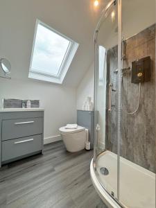 a bathroom with a shower and a toilet and a window at Eagles Cottage, 3 - Bed, Sleeps 6, Pets Welcome - Ulverston in Ulverston