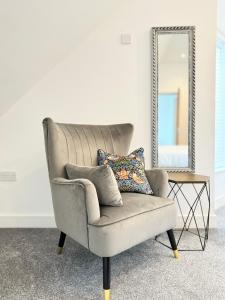 a gray chair sitting in front of a mirror at Eagles Cottage, 3 - Bed, Sleeps 6, Pets Welcome - Ulverston in Ulverston +43 photos