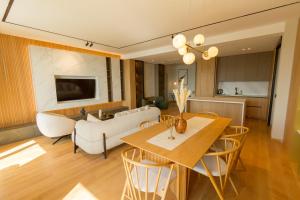 a dining room and living room with a table and chairs at Regent Resort Budva in Budva