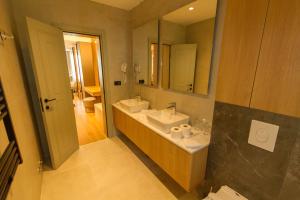 a bathroom with two sinks and a mirror at Regent Resort Budva in Budva