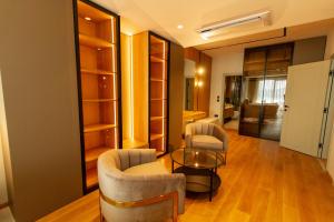 a living room with two chairs and a glass table at Regent Resort Budva in Budva