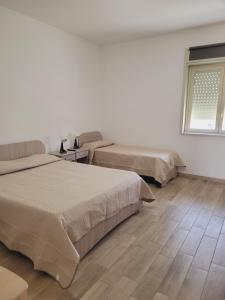 Postel nebo postele na pokoji v ubytování HOUSE AIRPORT Catania