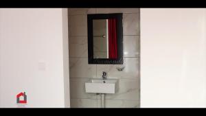 a bathroom with a sink and a mirror at Guest House Lina Elisa in Mindelo +12 photos